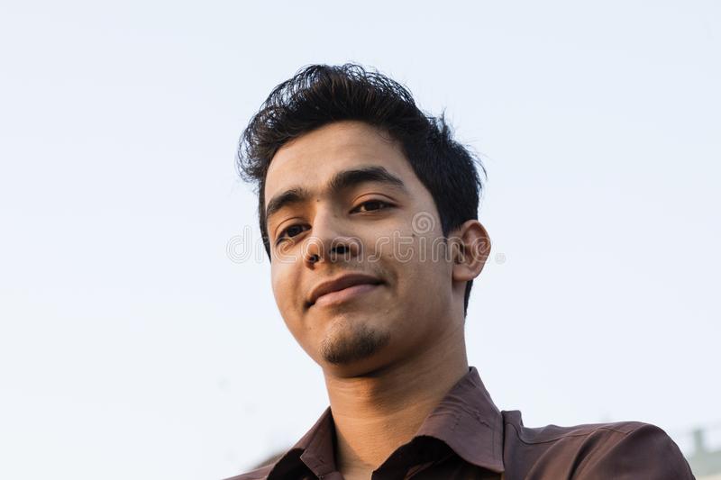 dhaka-bangladesh-february-portrait-smiling-young-bangladeshi-man-brown-shirt-evening-light-taken-below-115734074